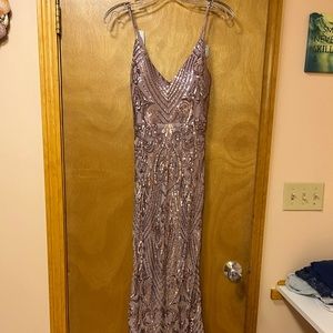Pinkish/purple prom dress with sequin designs. Size small. Never worn.